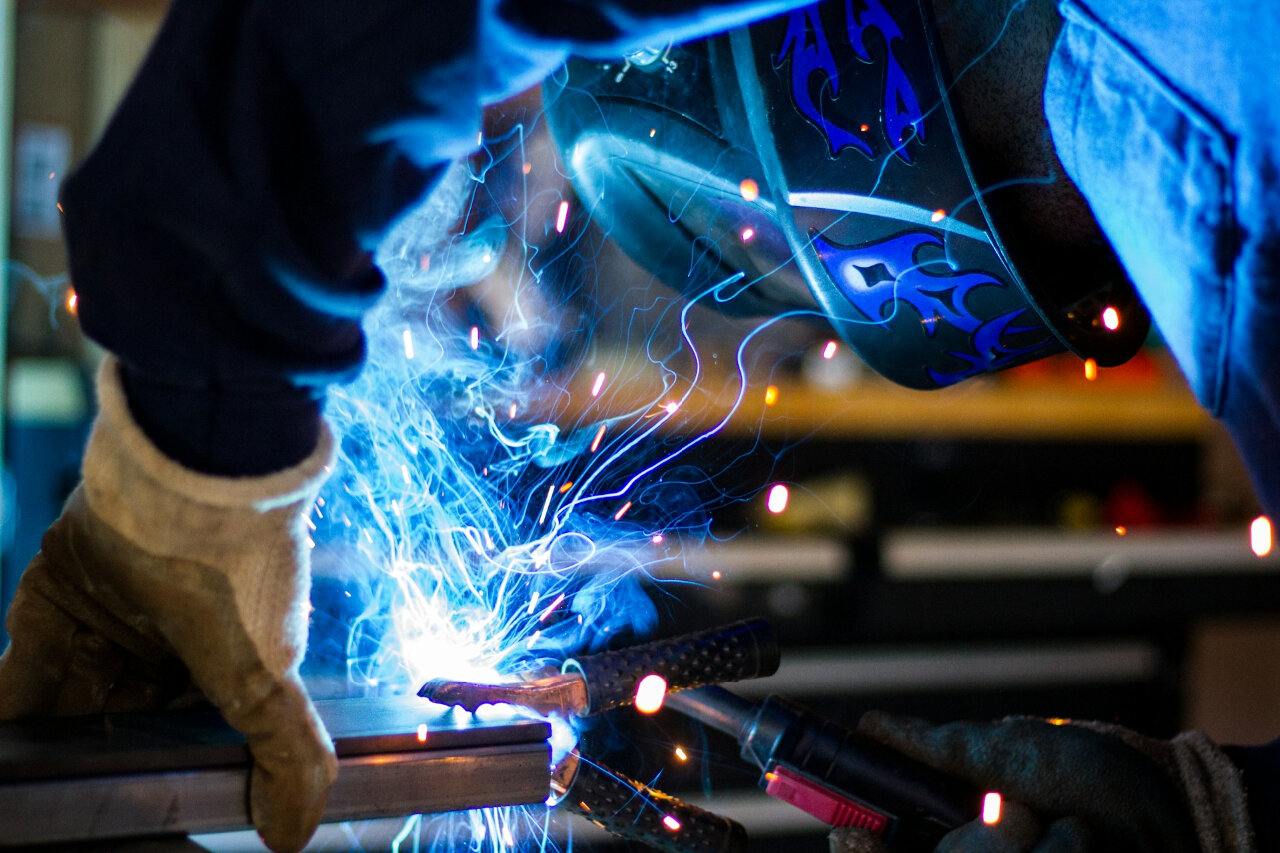 welder manufacturer working on a metal workpiece certified in AWS and CWB welding practices